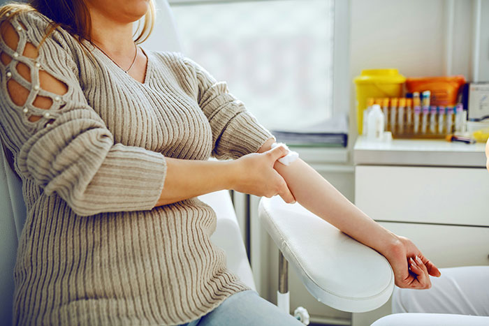 Person in a medical setting preparing for a blood test, highlighting unique rare statistics in health.
