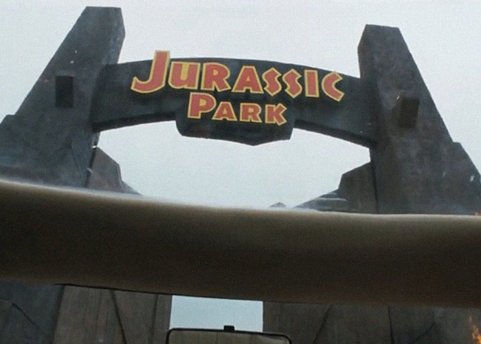 "Jurassic Park entrance gate with iconic logo from the movie, showcasing intriguing facts."