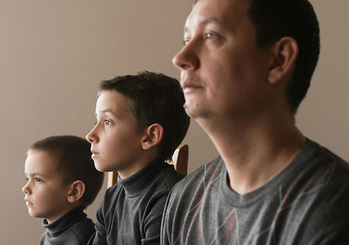 Three people looking forward, highlighting toxic family dynamics.