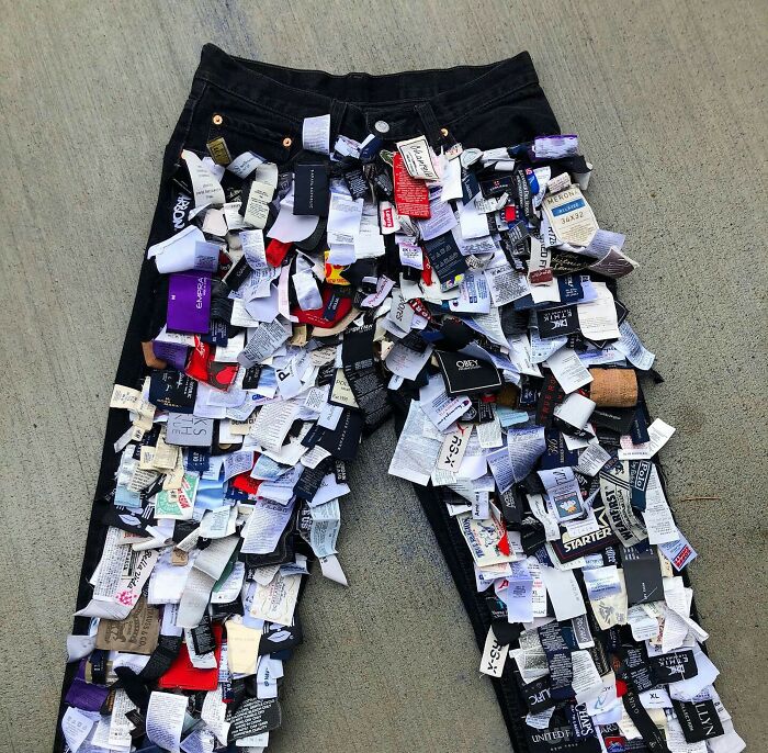 Jeans covered in assorted clothing labels, highlighting fashion trends predicted for 2025.