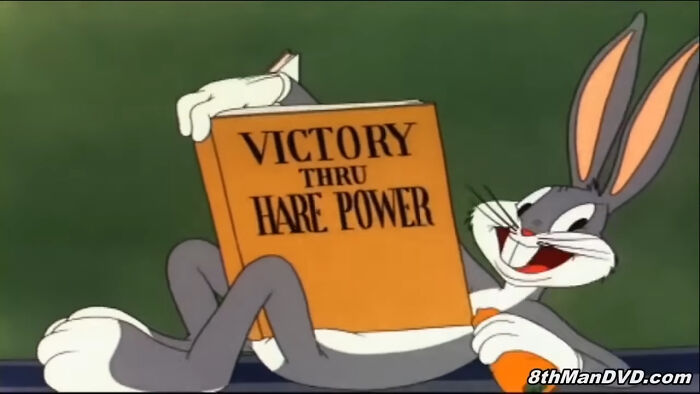 Bugs Bunny from "Looney Tunes" and "Merrie Melodies" smiling with book titled "Victory Thru Hare Power," holding a carrot, from the topic of villains actually not being that bad. 