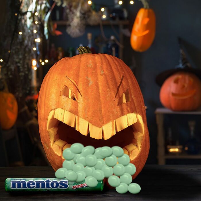 Funny pumpkin spewing mints for a social media post, surrounded by Halloween decorations.