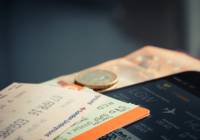 Airline tickets and currency on a table, symbolizing a planned Japan trip cancellation. Airline tickets and currency on a table, symbolizing a planned Japan trip cancellation.