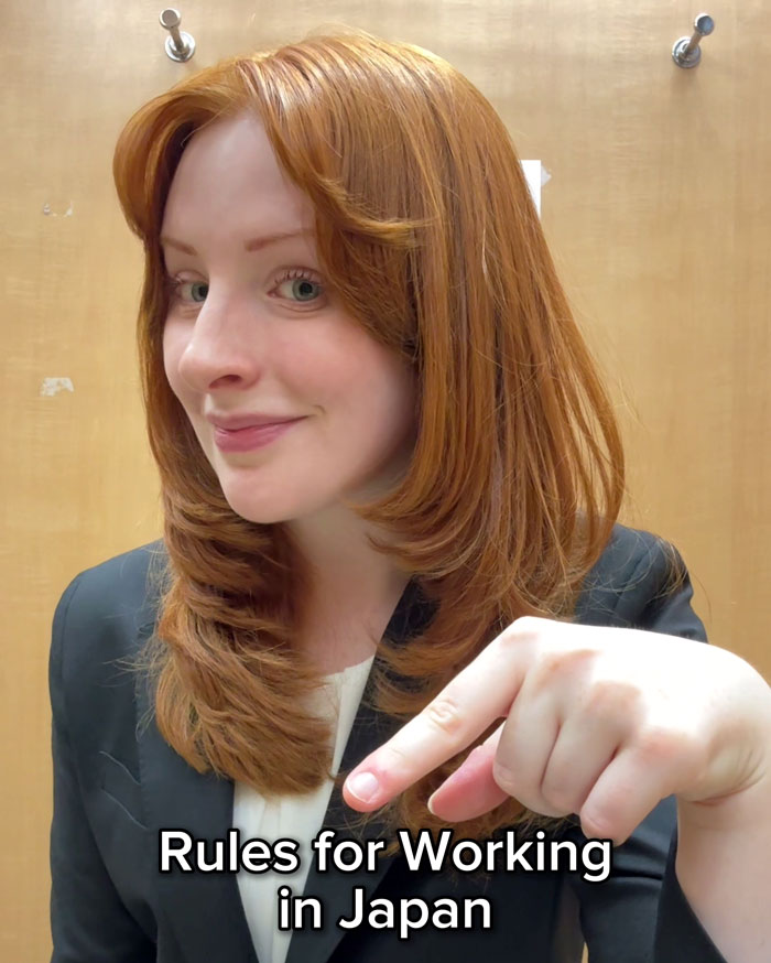 Woman highlighting work rules in Japan, smiling and pointing with a finger. Woman highlighting work rules in Japan, smiling and pointing with a finger.