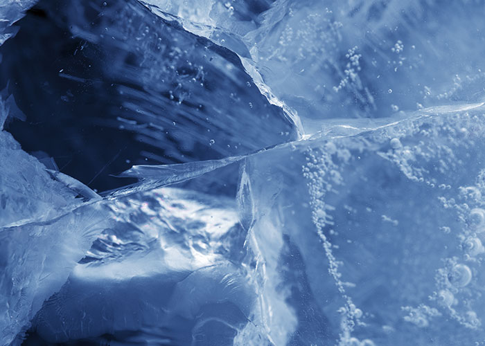 Close-up of floating ice structures at sea, capturing intricate details and bubbles, evoking caution for wild sightings.