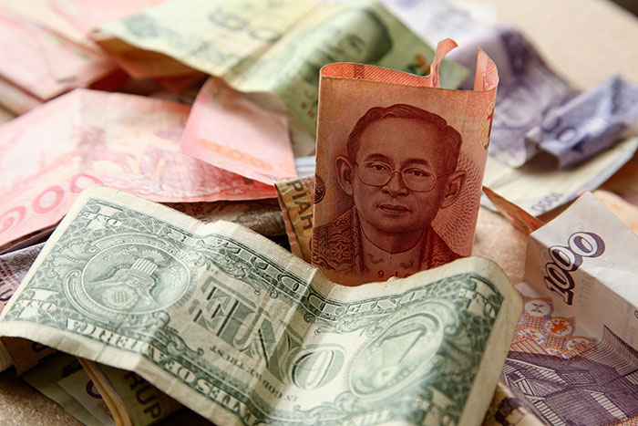 Various international currency notes scattered, representing wealth and rich kids.