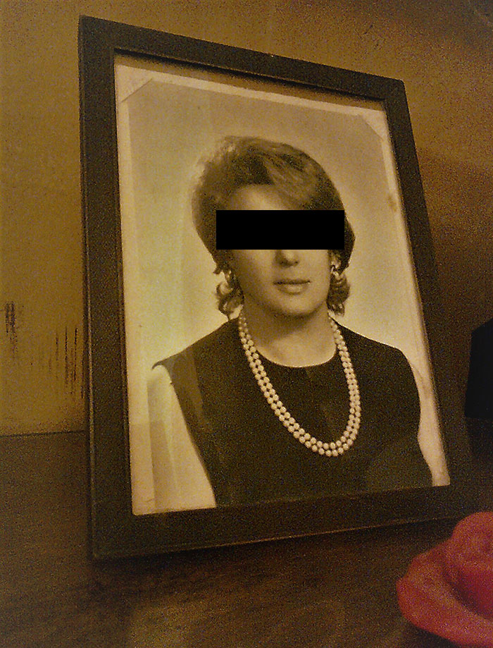 Black and white portrait in a frame, part of unwanted Christmas presents.