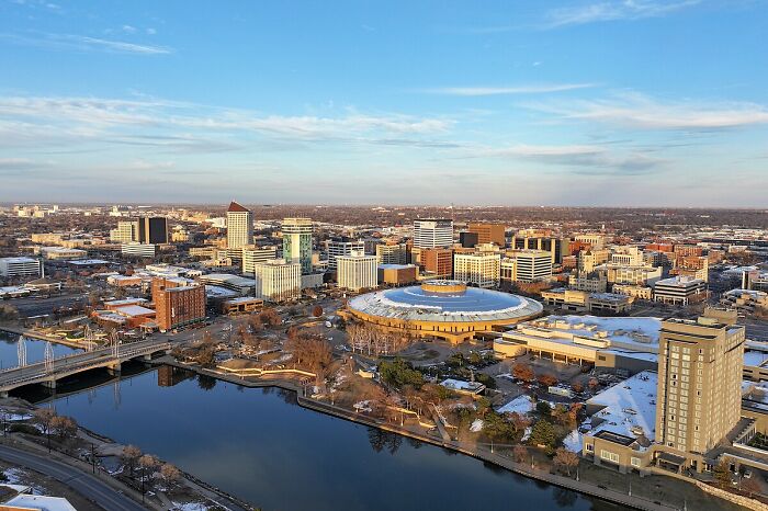 Aerial view of a city skyline with a river, showcasing a potential worst-city-country trip destination.