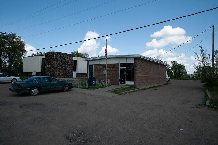 A small town building under a clear sky, representing wrost-city-country-trip.