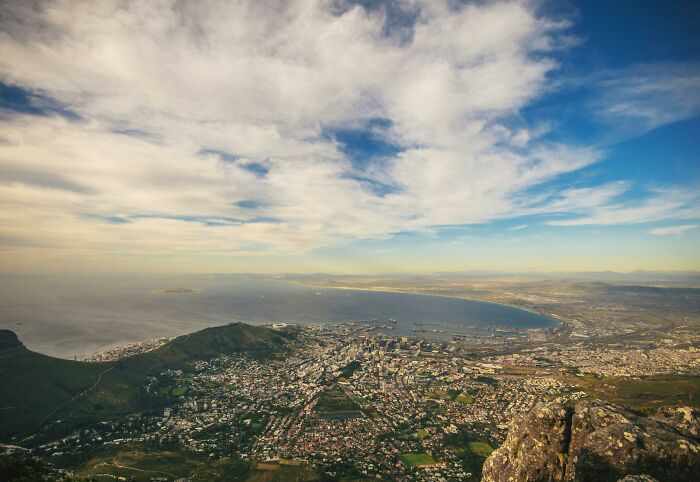 Aerial view of a coastal city highlighting natural beauty, relevant to the wrost-city-country-trip theme.