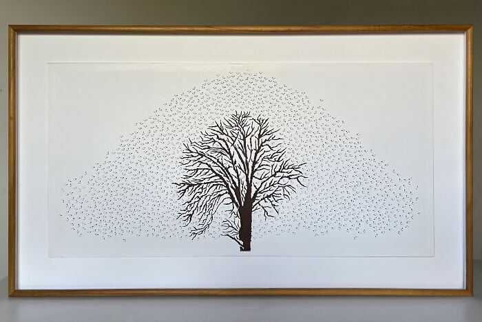 Intricate paper cut design depicting a tree-less existence, framed artwork with detailed branch patterns.
