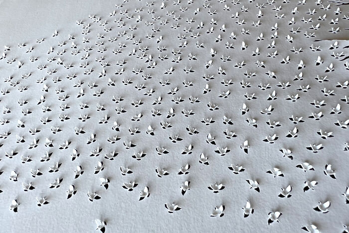 Intricate paper cut design illustrating tree-less existence with delicate, leaf-like patterns on a textured surface.