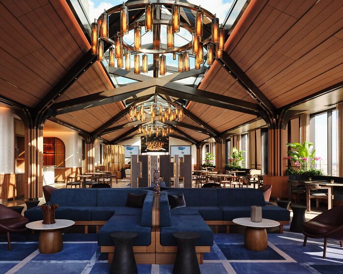 Luxurious interior design with a vaulted ceiling, elegant chandeliers, and modern seating area, showcasing award-winning style.