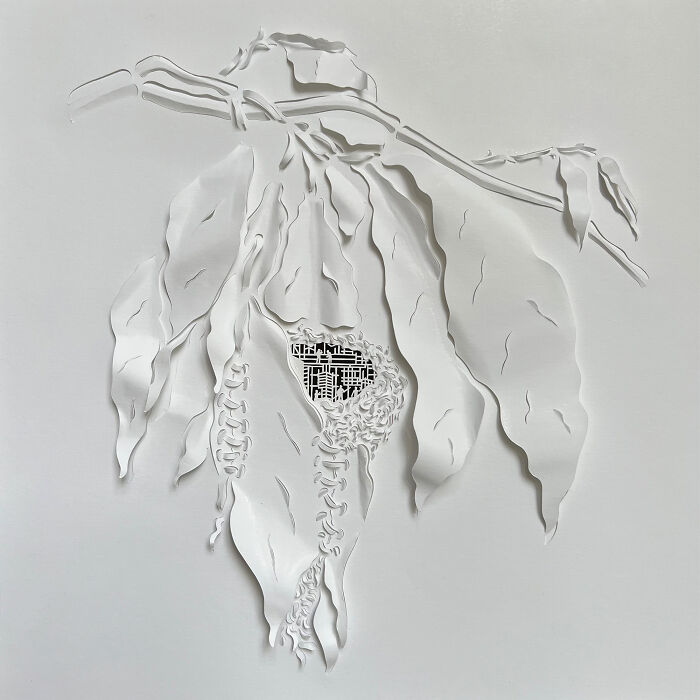 Intricate paper cut design depicting tree-less existence with detailed layered leaves and abstract patterns.