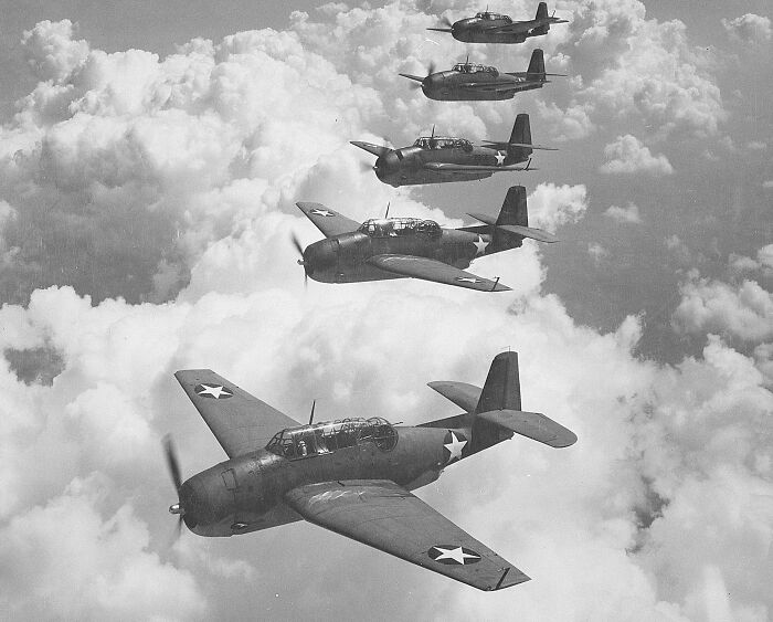Five military planes flying in formation in the clouds, representing weird unsolved mysteries.