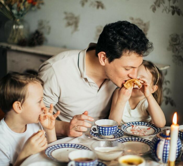 Father enjoying breakfast with kids at a cozy table setting, highlighting moments men shouldn’t be judged for.