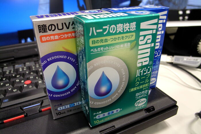 Eye drop packaging on a laptop, showcasing everyday items that might seem harmless.