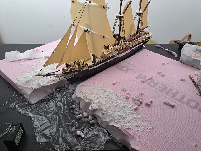 LEGO model of a ship simulating the Imperial Trans-Antarctic Expedition setting on a textured pink surface.