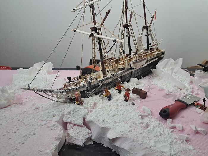 LEGO recreated Imperial Trans-Antarctic Expedition ship amidst snow-like terrain with mini figures.