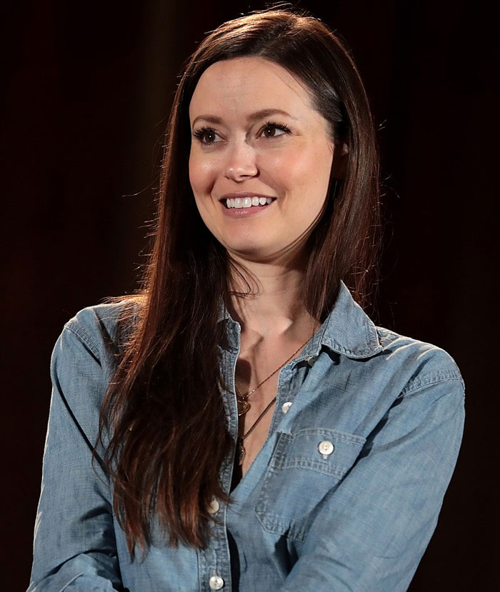 A person smiling in a denim shirt, representing celebrities with fading fame.
