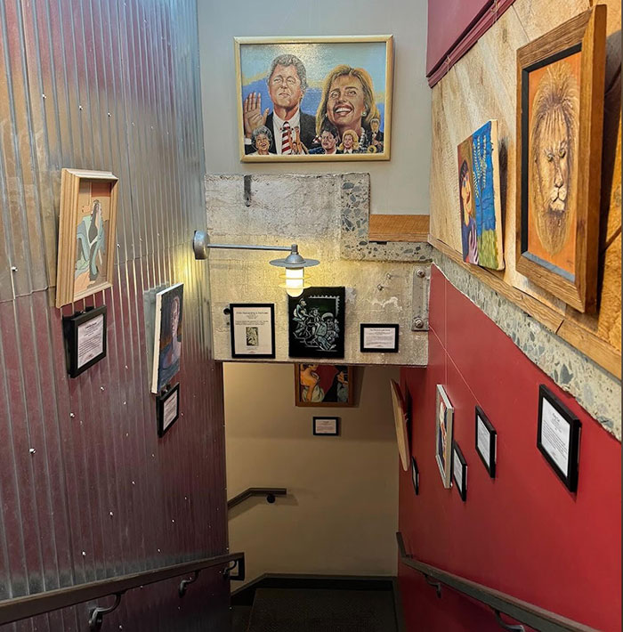 Stairway gallery with a painting depicting a couple, inspired by a viral painting of a man's wife. Stairway gallery with a painting depicting a couple, inspired by a viral painting of a man's wife.
