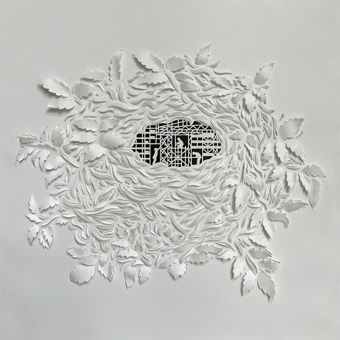 Intricate paper cut design featuring a tree-less concept with detailed leaf patterns surrounding a geometric center.