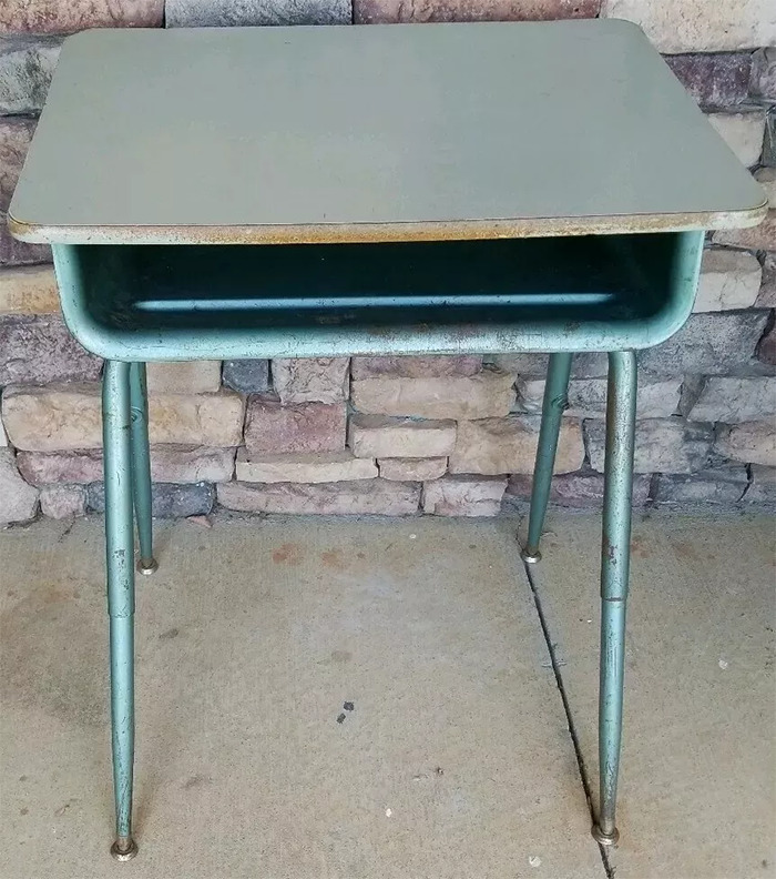 Old-school item, a vintage metal and wood school desk, evoking memories of classroom days.