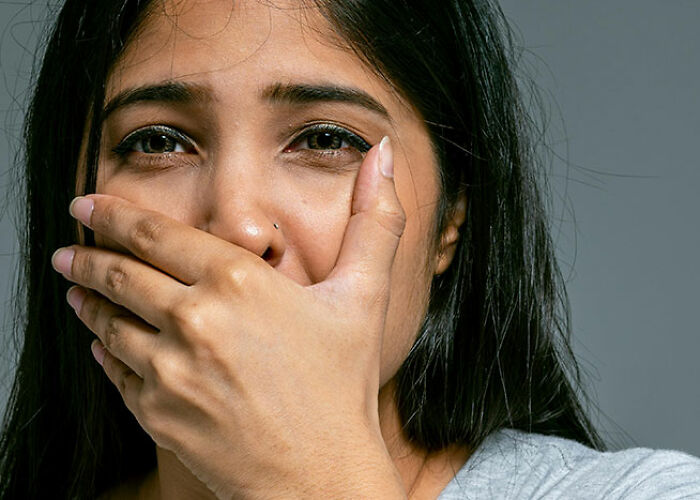 A woman covers her mouth with her hand, expressing surprise or disbelief, highlighting the concept of life hacks.