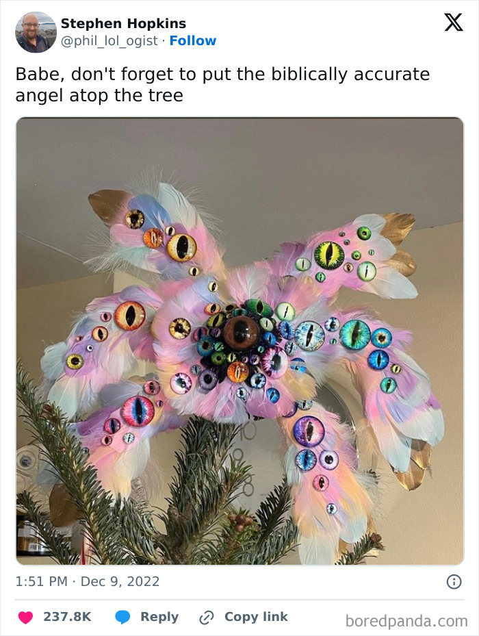 Biblically accurate angel tree topper, adorned with numerous colorful eyes on pink feathers.