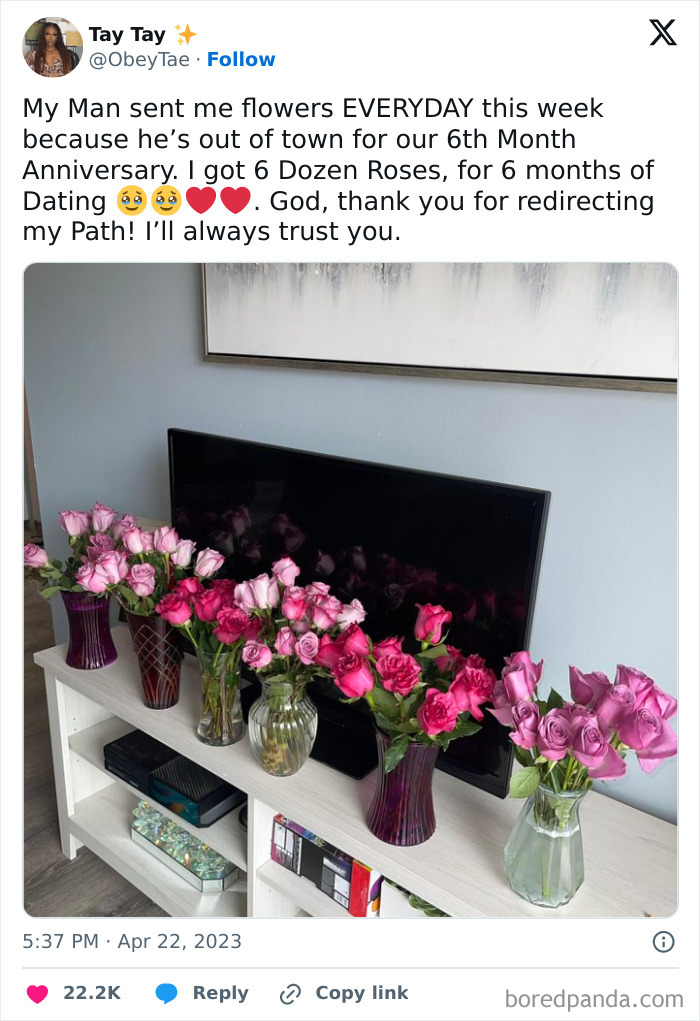 Bouquets of pink roses in glass vases on a shelf, celebrating a funny wholesome anniversary surprise.
