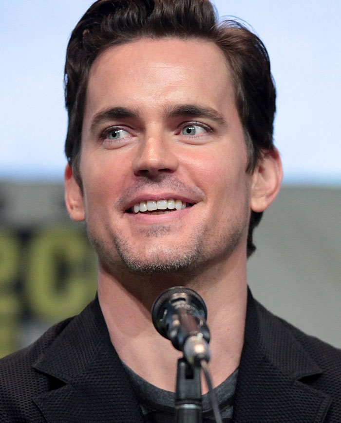 Man smiling at a press event, symbolizing celebrities who slowly lost fame.