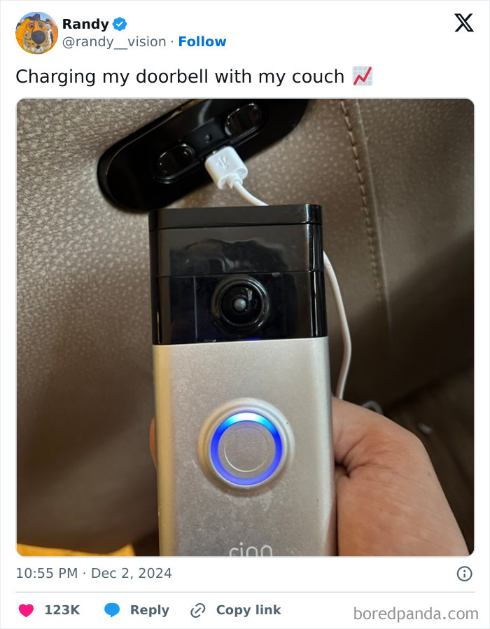 Close-up of a doorbell being humorously charged via a couch, capturing one of the funniest tweets of the month.