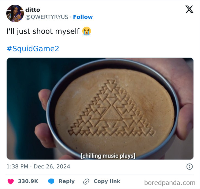 A hand holding a Squid Game 2 honeycomb cookie with a complex triangle pattern.