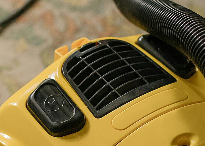 Yellow vacuum cleaner close-up showcasing practical life hacks people swear by.