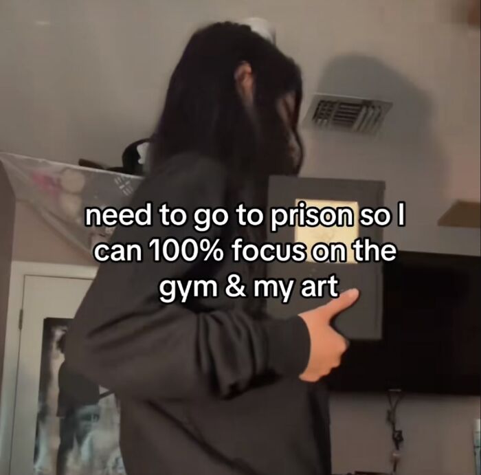 Person holding a book with a humorous meme text about focusing on gym and art, shared by a dedicated IG page.