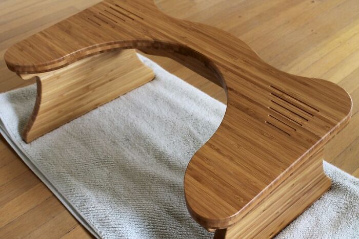 Bamboo footrest on a rug, a purchase that improved lives by enhancing comfort and well-being.