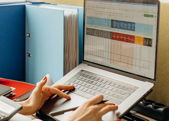 Person using a laptop with a spreadsheet, showcasing life hacks for organizing data efficiently.