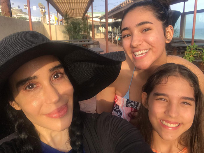 Nadya Suleman with two of her children, smiling outdoors. Nadya Suleman with two of her children, smiling outdoors.