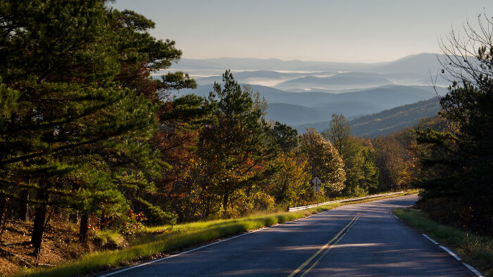 Scenic highway with amazing views of rolling hills and lush forests in the background.