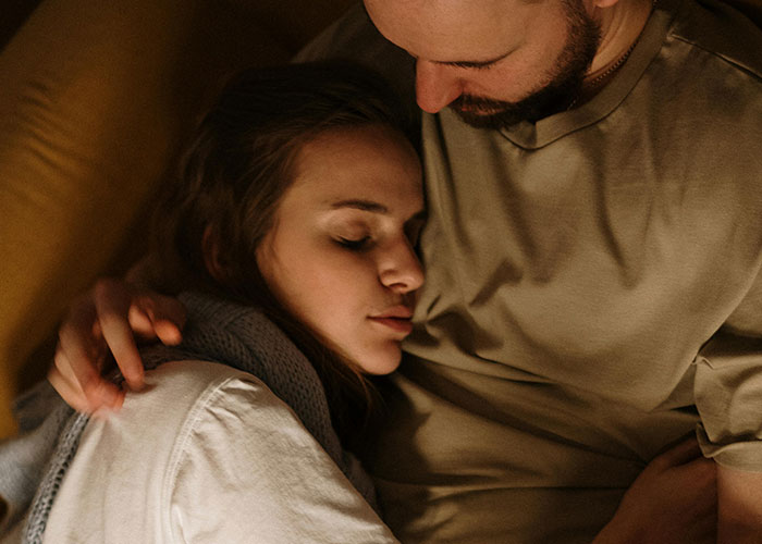 A couple embracing on a sofa, illustrating relationship moments that highlight how he's different.