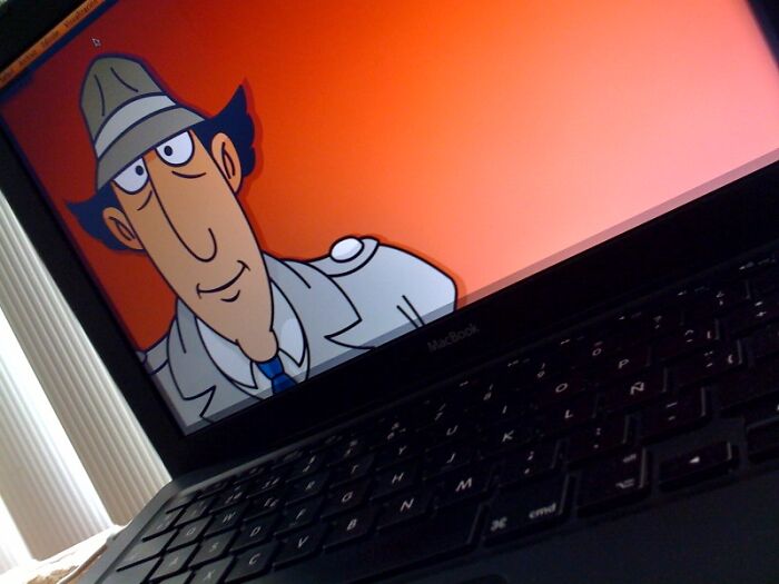 Cartoon detective character on a laptop screen, reflecting quirky traits often labeled as weird in school environments.
