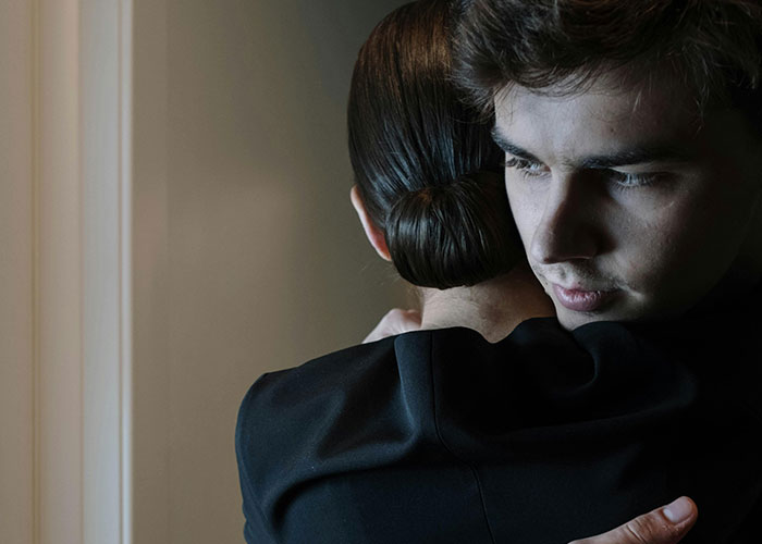 A man hugging a woman, conveying a sense of being different and thoughtful.