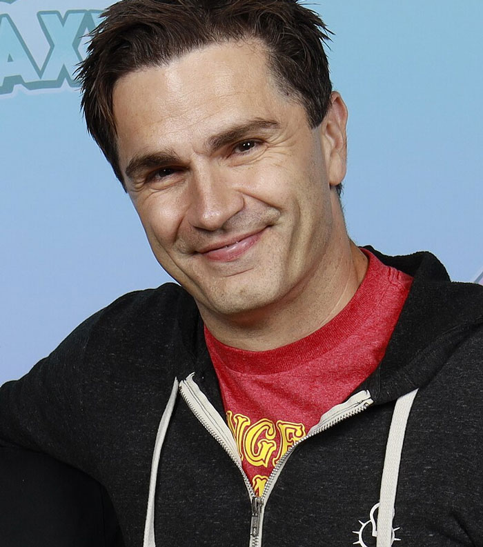 "Person in casual attire smiling, representing celebrities who lost fame."