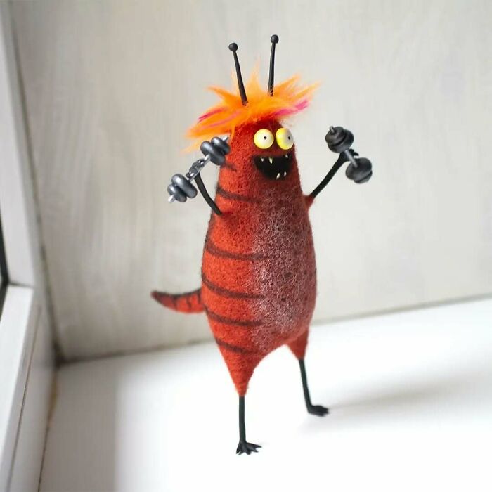 Funny-looking animal doll with bright colors created by a Georgian artist, featuring quirky arms and vibrant hair.