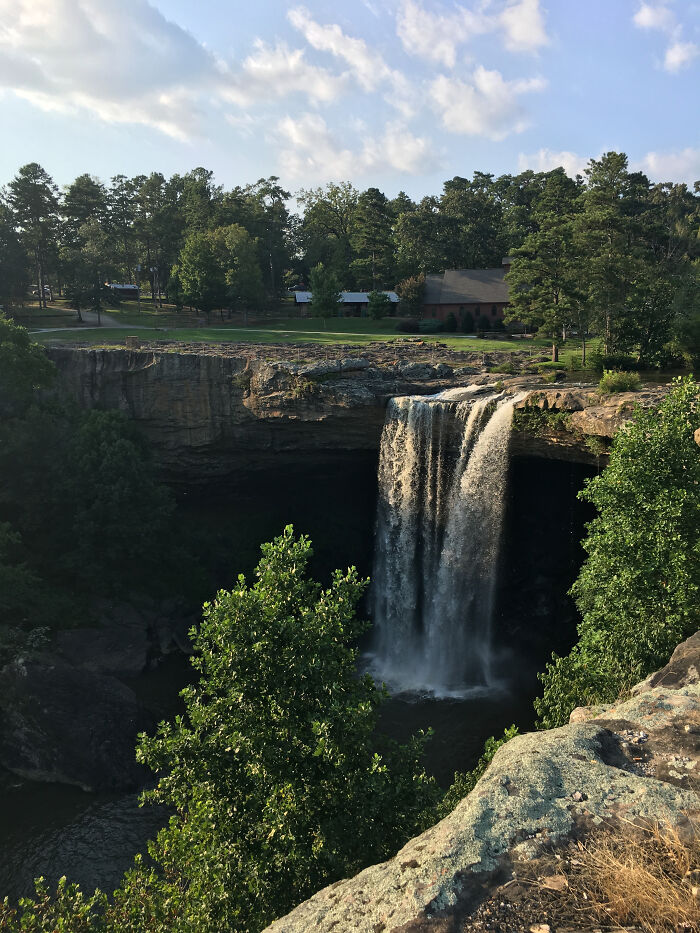 Waterfall surrounded by trees in one of the amazing views states, capturing the serene natural scenery.