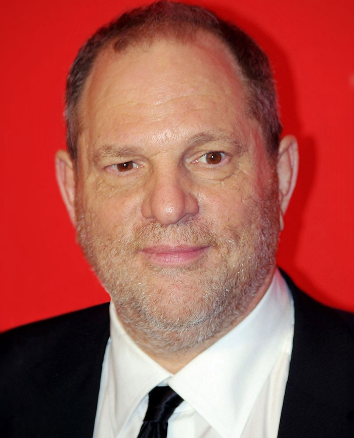 A person in a suit against a red background, highlighting a celebrity who lost fame.