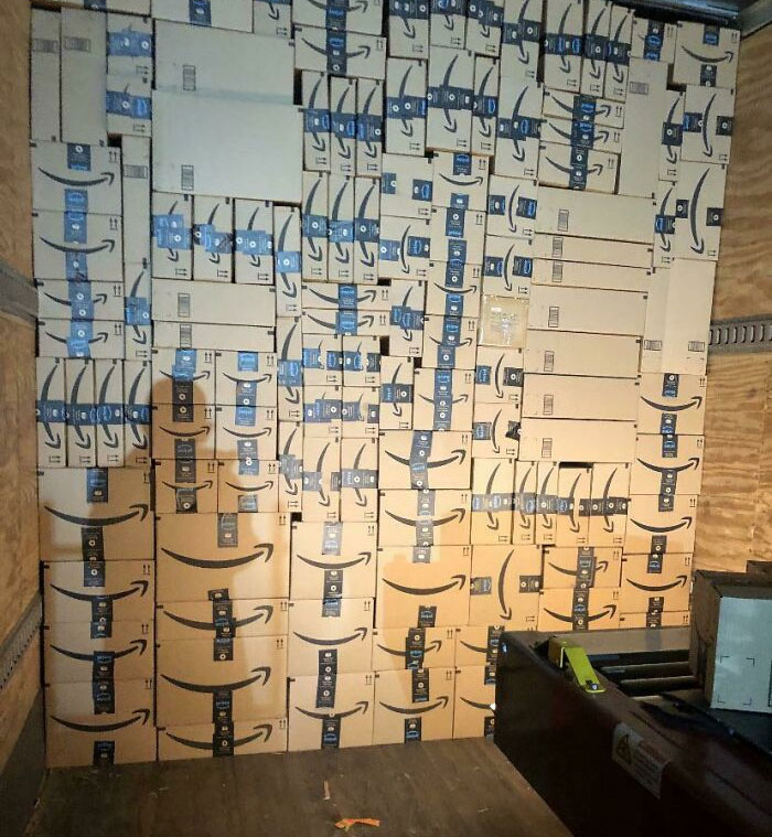 Neatly stacked Amazon boxes in a truck showcasing next-level organization skills.