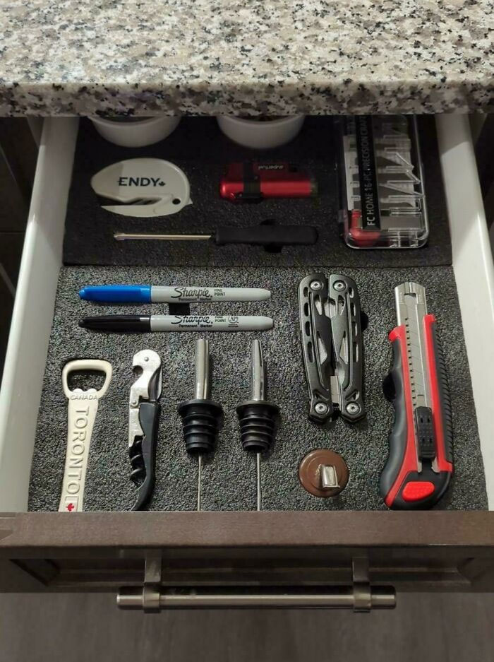 Neatly organized drawer with various tools and office items, showcasing next-level organization.