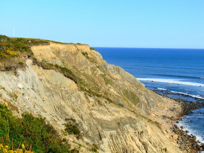 Rocky coastal cliffside with ocean view, featuring amazing views of coastal states.