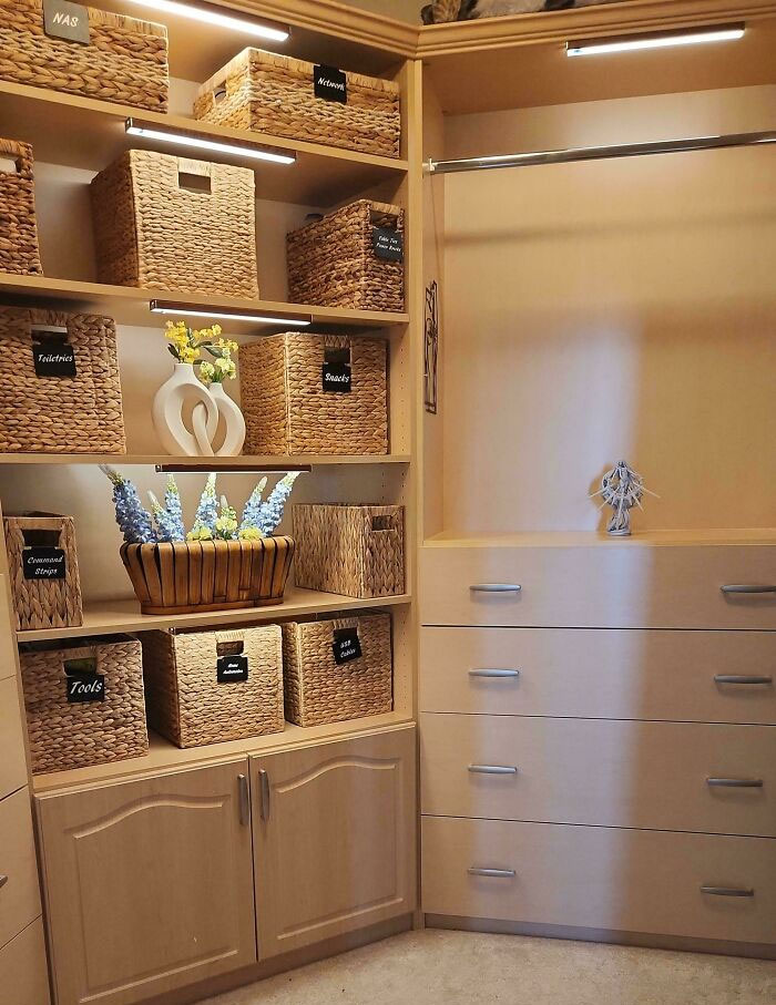 Organized closet with wicker baskets neatly labeled and arranged on shelves for optimal organization.